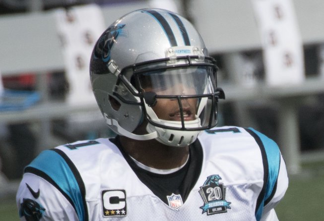 Cam Newton jogging onto the field