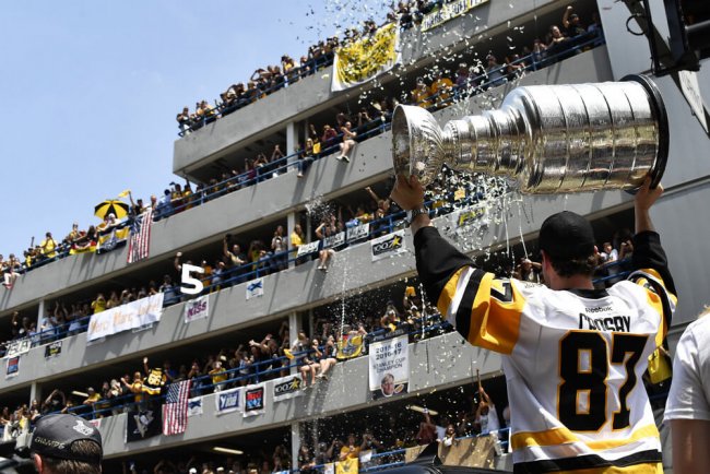 PITTSBURGH, PA - JUNE 14: Pittsburgh Penguins center Sidney Crosby (87) hoists the Stanley Cup in celebration during the 2017 Pittsburgh Penguins Stanley Cup Champion Victory Parade on June 14, 2017 in Pittsburgh, PA.