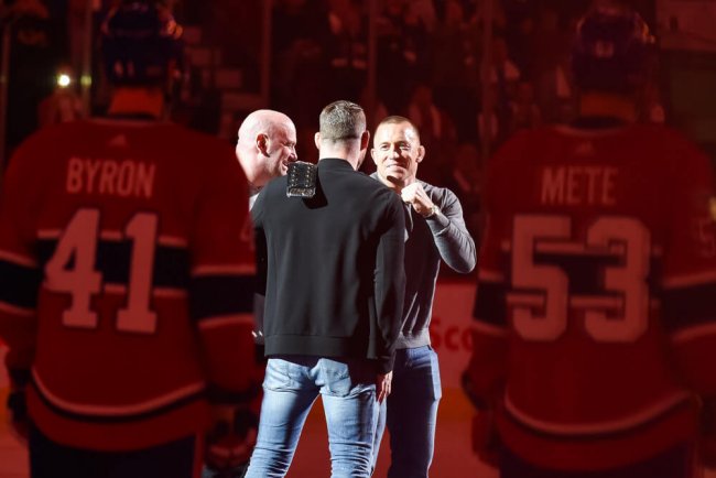 MONTREAL, QC - OCTOBER 14: UFC George St-Pierre facing UFC Michael Bisping at center ice prior to the Toronto Maple Leafs versus the Montreal Canadiens game on October 14, 2017, at Bell Centre in Montreal, QC