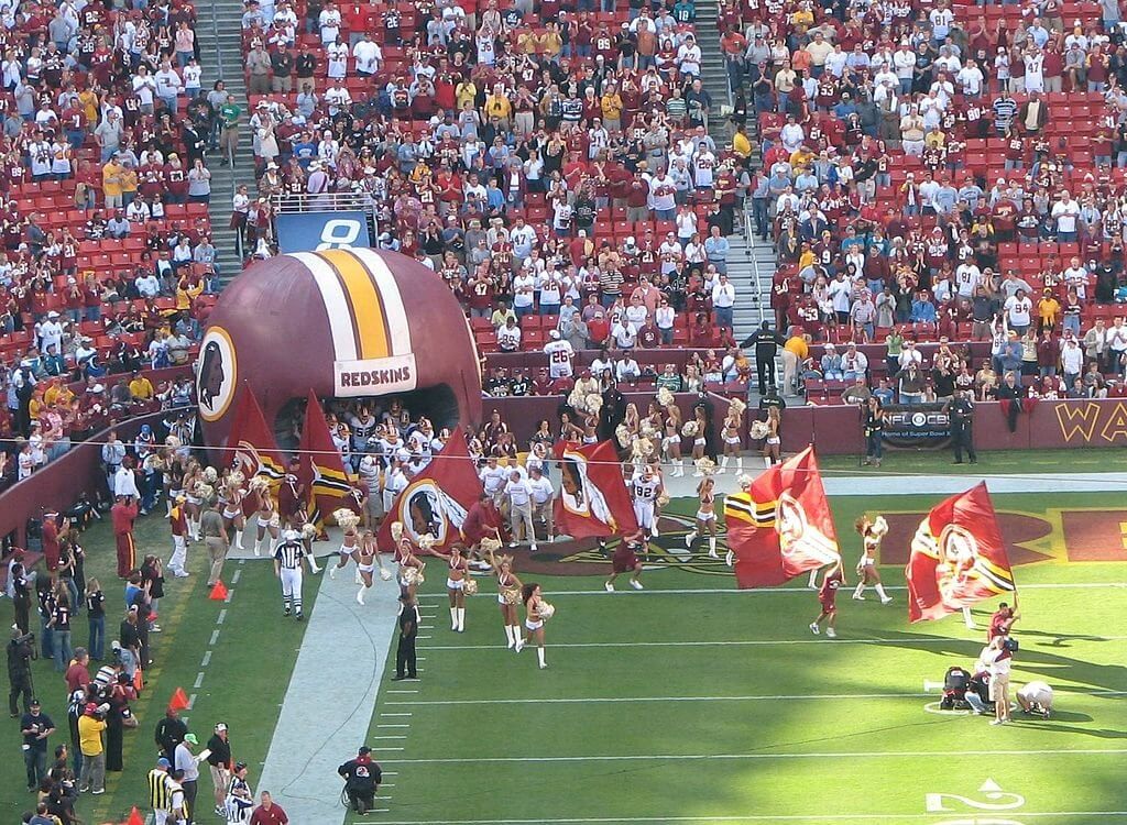 Washington runs out of the tunnel at FedEx Field