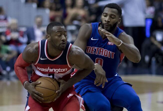 Detroit's Andre Drummond attempts to slow down Washington's John Wall
