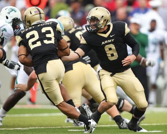A photo of the Army QB handing the ball off to his RB