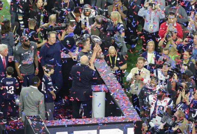 Tom Brady celebrating with the Lombardi Trophy.