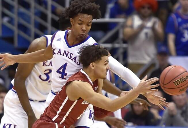 Can Anyone Catch Trae Young for 2018 Player of the Year? Trae Young of Oklahoma guarded by Devonte Graham of Kansas
