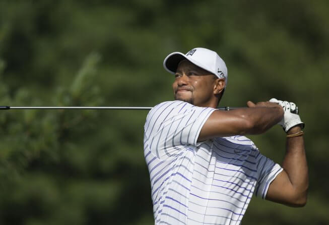 Tiger Woods pauses at the end of his swing.