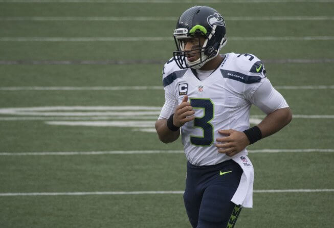 Seahawks QB Russell Wilson jogging off the field.