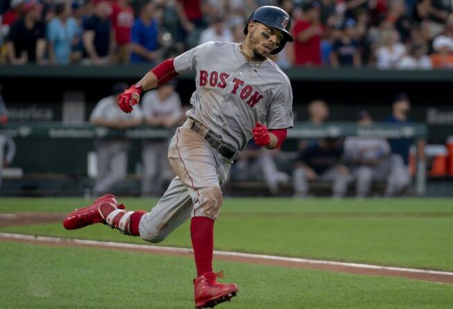 Mookie Betts runs to first base.