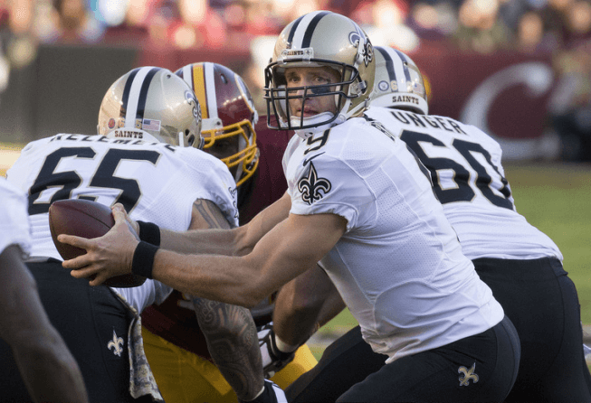 Saints QB Drew Brees handing the ball off.