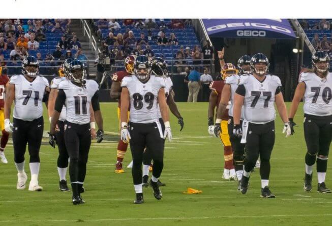 Baltimore Ravens walking to the huddle